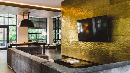 TV lounge with flatscreen on gold wall and a pool table