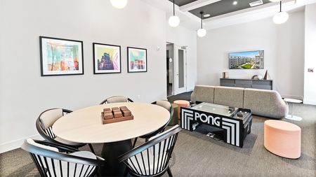 Gaming area with pong table and lounge areas at Modera Framingham apartments.