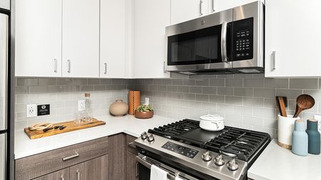 Stainless steel appliances with gas range in a Modera Framingham apartment.
