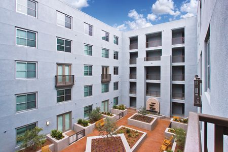 Outdoor courtyard with plant beds and water feature