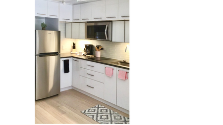Micro-apartment kitchen with white cabinets