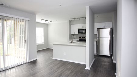 Open Floor Plans with Kitchens Overlooking Living Spaces in an Alister Town Center apartment.