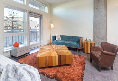 large living room looking onto private patio at modera river north apartment homes for rent in denver colorado