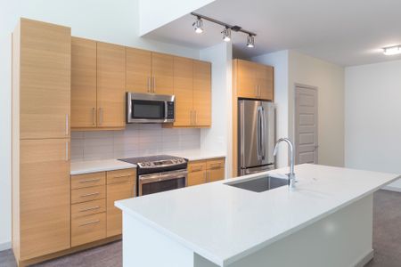 kitchen with large island and premium appliances at modera river north apartment homes for rent in denver colorado