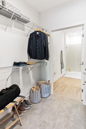 Large pass-through closets with built-in shelving in a Modera Framingham apartment.