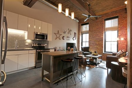 Polished Concrete Floors Throughout and Original Brick and Wood Beams Accent Apartments