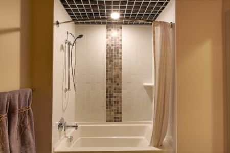 Luxury Bathrooms with Soaking Tub and Decorative Tile at Modera Lofts apartments.