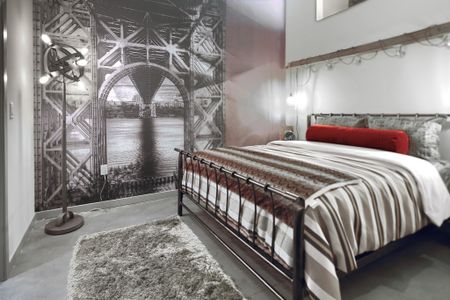 Elegant Master Bedroom Incorporates Historic Elements at Modera Lofts, apartments in Jersey City.
