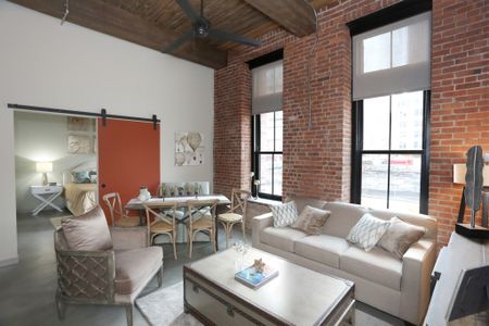 Living room with large windows  in apartment at Modera Lofts apartments.