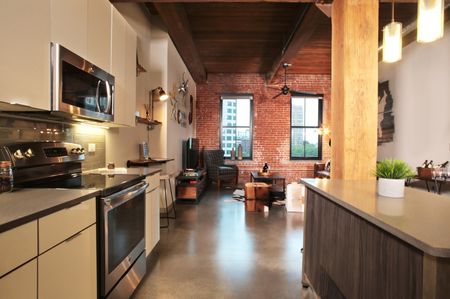 high end kitchen leading onto open floor plan living area at modera lofts apartment homes for rent