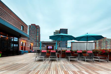 Roof Top Entertainment Area with Chaise Lounge Seating at Modera Lofts apartments.