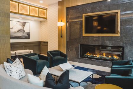 modern clubhouse with cozy fireplace at Modera Frisco Square apartments