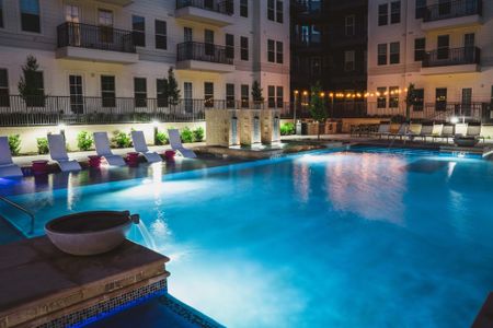 Resort-style pool in the evening at Modera Frisco Square apartments