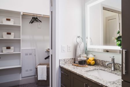 spa-like bathroom with granite countertops and upscale finishes in a Modera Frisco Square apartment