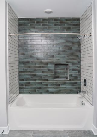 tile bathtub with premium fixtures at modera germantown apartment homes for rent in nashville tennessee