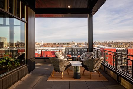 outdoor rooftop lounge seating area with city view at modera art park apartment homes for rent in denver colorado