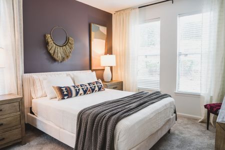 bedroom with furniture and large windows at alister lake lynn apartment homes for rent in raleigh north carolina