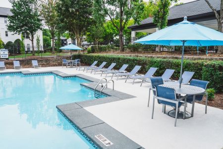 pool deck with lounge chairs and pool at alister lake lynn apartment homes for rent in raleigh north carolina