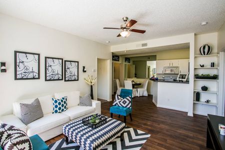 Apartments for Rent in North Las Vegas, NV - Desert Ridge - Cozy Living Room with Wood Plank Flooring, Ceiling Fan, and Furniture