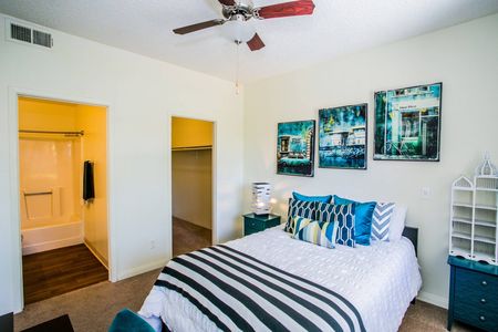2 BR Apartments in North Las Vegas, NV - Desert Ridge - Well Lit Bedroom with Oversized Closet, Attached Bathroom, Queen Bed, and Carpeted Flooring