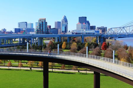 Elevated walkway over a park near our apartments in Louisville, featuring a view of the Louisville skyline.