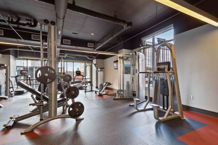 The fitness center at our apartments for rent in Ann Arbor, featuring weight lifting machines and treadmills.