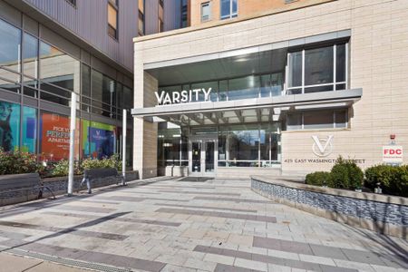 The entrance to The Varsity apartment complex in Ann Arbor, featuring a view of the modern exterior and doorways.