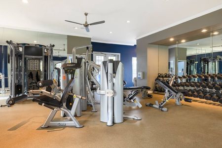 Fitness center at our apartments for rent near Penn State, featuring treadmills, spin bikes, and free weights.