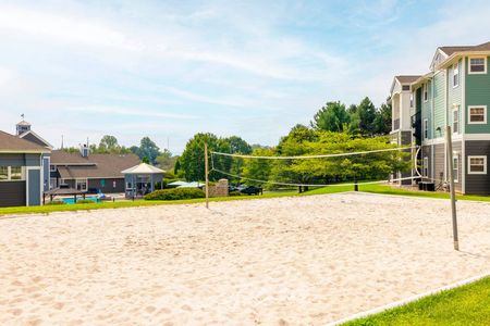 The volleyball courts at our apartments for rent near Penn State, featuring a sand court with a view of the apartments.