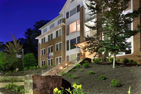 Nighttime exterior view of apartment and grounds