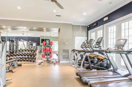 Fitness center at our apartments for rent near Penn State, featuring treadmills, spin bikes, and free weights.