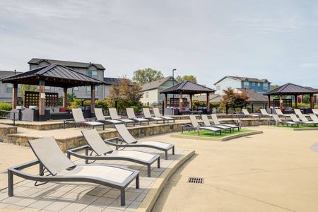 Outdoor lounge at our apartments for rent in Louisville, featuring beach chairs, shade structures, and outdoor couches.