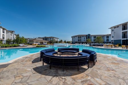 Photo of the outdoor pool area at our luxury Morgantown apartments, featuring blue outdoor circular seating.