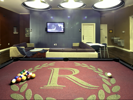 Pool table, flat screen TV and seating area in the game room at The Reserve on West 31st