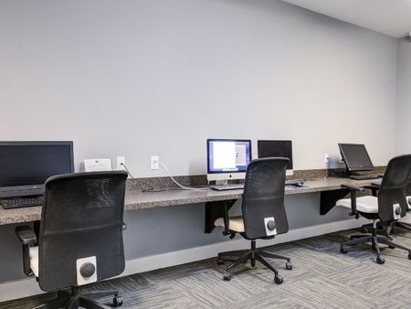 Business center with computers and seating for residents to utilize.