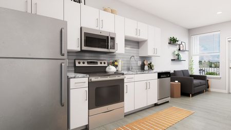 Model kitchen at our apartments in Orlando, featuring wood grain floor paneling and marble countertops.