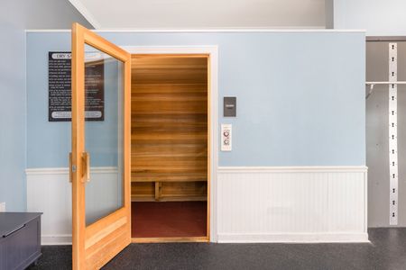 The sauna at our student apartments near Penn State, featuring wood grain interiors and a control button on the outside.