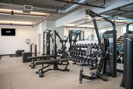 Fitness Center complete with free weights, benches, and other work out equipment
