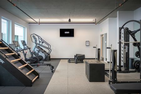 Fitness Center with stair climber, stationary bikes, and various cross fit style workout equipment