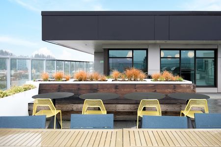 Outdoor rooftop lounge with seating overlooking the city of Eugene
