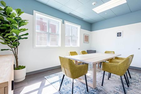 The conference room at our student apartments in Syracuse, featuring a conference table surrounded by chairs.
