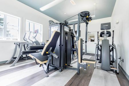 The fitness center at our apartments for rent in Syracuse, featuring treadmills and windows with a view.
