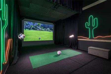 Picture of the sports simulator room where residents can play interactive sports games