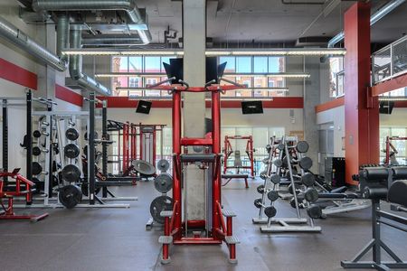 First floor of the fitness center with various workout equipment machines and free weights