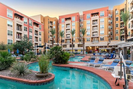 Lazy river with sun loungers and the apartments in the background overlooking the pool deck