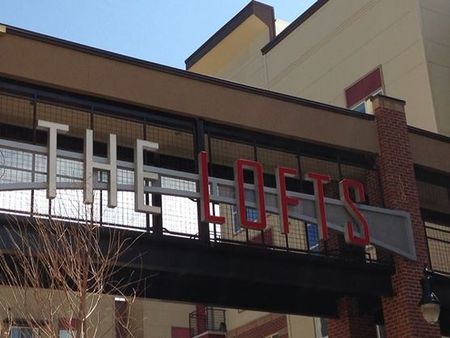 Lofts at City Center exterior sign on bridge walkway