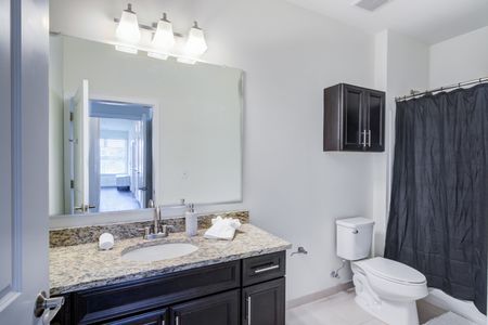 Model bathroom at our student housing in Storrs, CT, featuring tiled flooring and a shower / bath combo.
