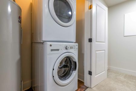 Model apartment stackable washer and dryer in laundry closet