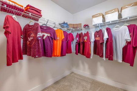 Spacious walk in closet with a lot of storage space in the model apartment