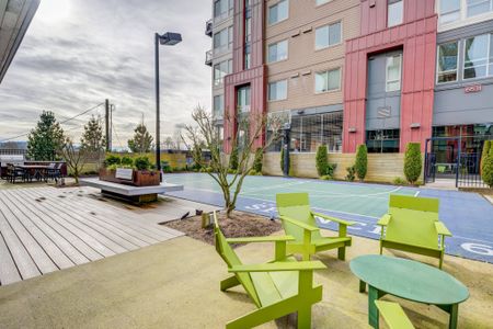 Outdoor patio with light green chairs outside apartments near Bothell WA.